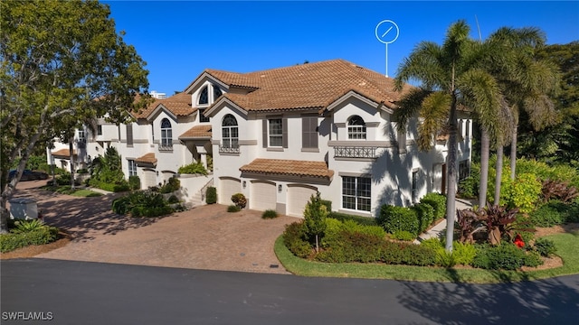 mediterranean / spanish house with a garage