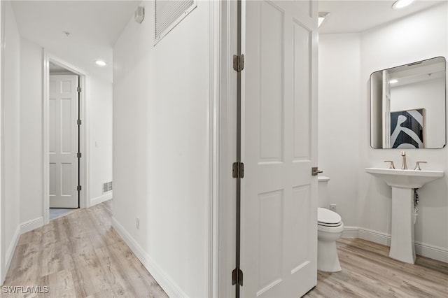 bathroom featuring toilet and hardwood / wood-style flooring