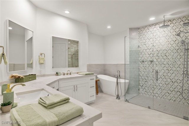 bathroom featuring vanity and separate shower and tub