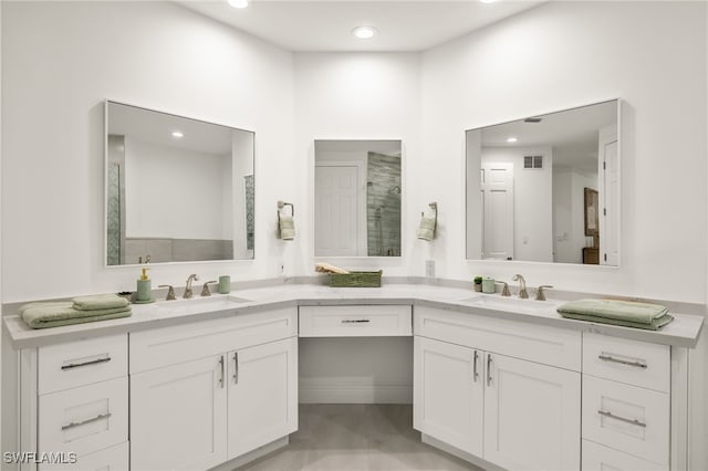 bathroom featuring a shower and vanity