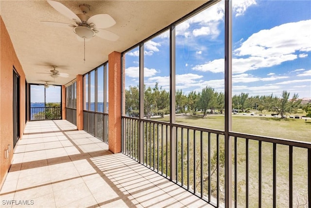 unfurnished sunroom featuring plenty of natural light and ceiling fan