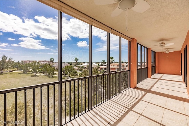 unfurnished sunroom with ceiling fan and plenty of natural light