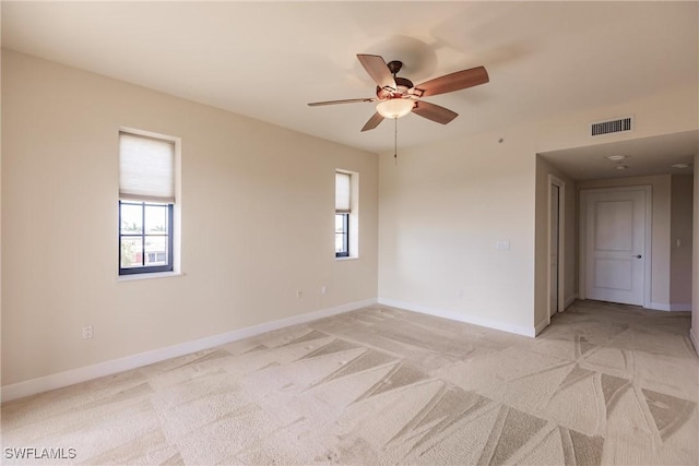 unfurnished room featuring ceiling fan and light colored carpet