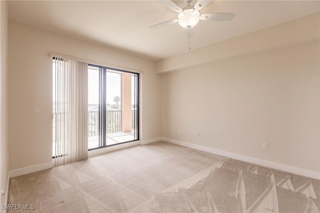 empty room featuring ceiling fan and light colored carpet