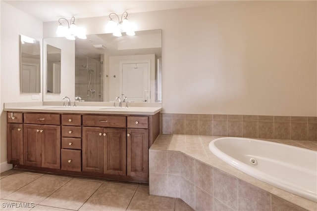 bathroom featuring plus walk in shower, tile patterned flooring, vanity, and an inviting chandelier