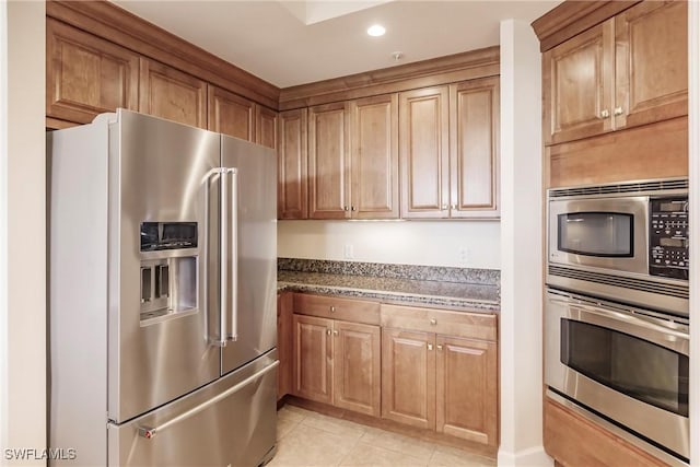 kitchen with appliances with stainless steel finishes and light tile patterned flooring