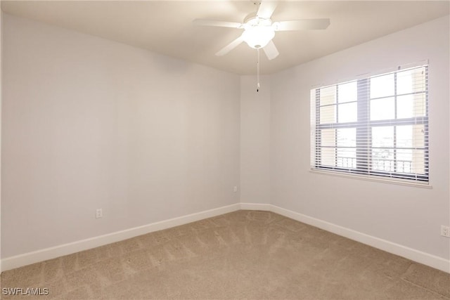 carpeted empty room featuring ceiling fan