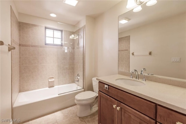 full bathroom with tile patterned floors, vanity, tiled shower / bath combo, and toilet