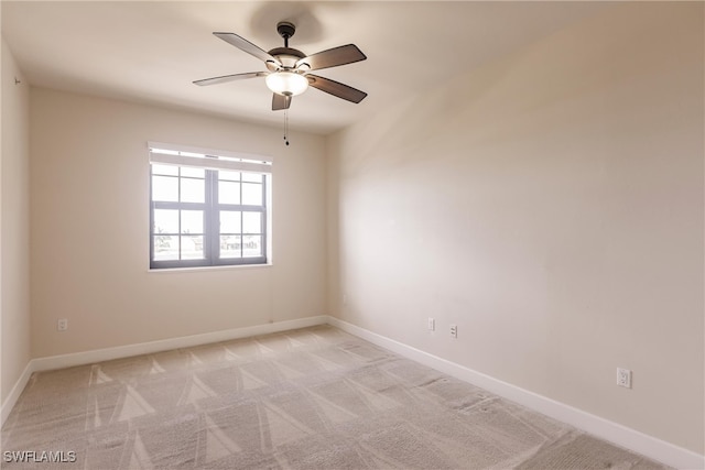 spare room featuring ceiling fan and light colored carpet