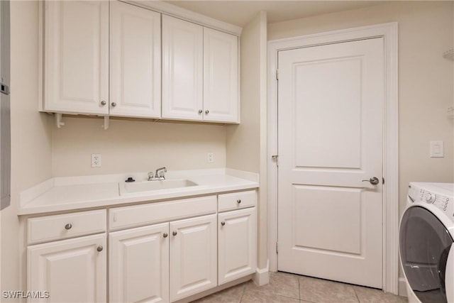 laundry room featuring cabinets, light tile patterned floors, washer / clothes dryer, and sink