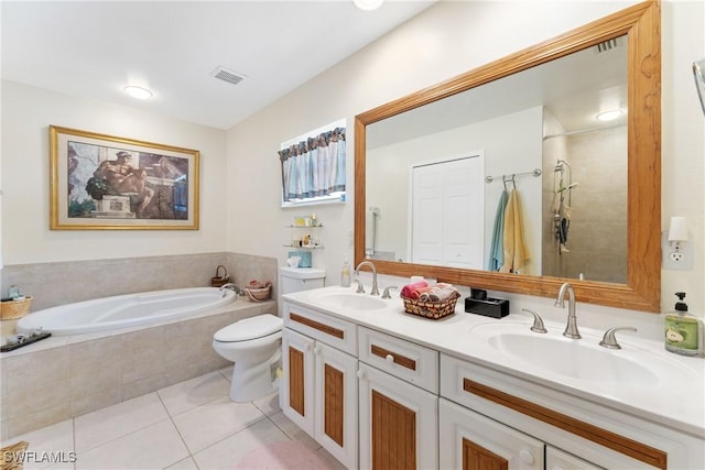 full bathroom with tile patterned flooring, vanity, shower with separate bathtub, and toilet