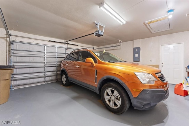 garage featuring electric panel and a garage door opener