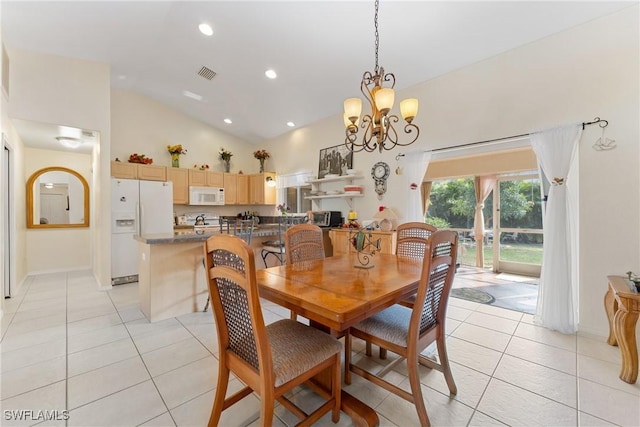 tiled dining space with high vaulted ceiling and an inviting chandelier