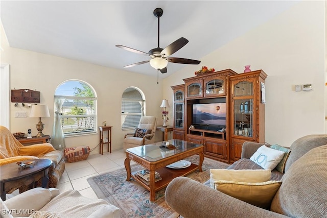 tiled living room with ceiling fan and lofted ceiling