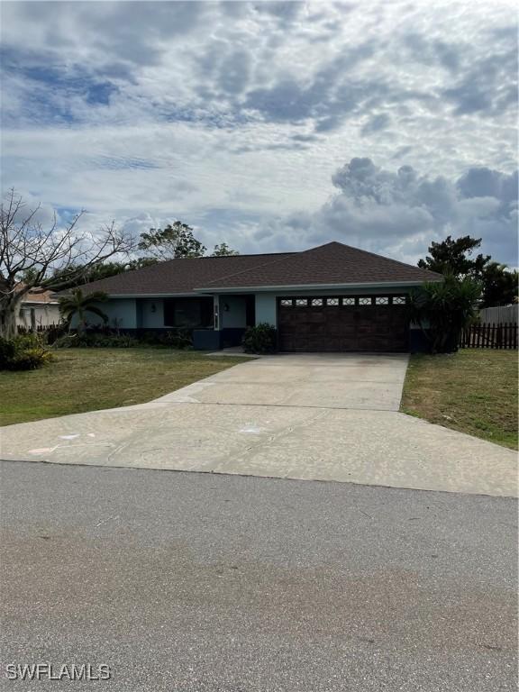 view of front facade with a garage and a front lawn