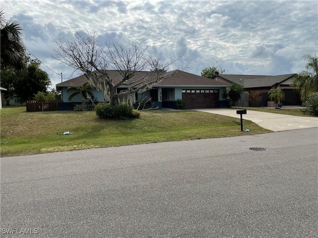 single story home with a front yard and a garage