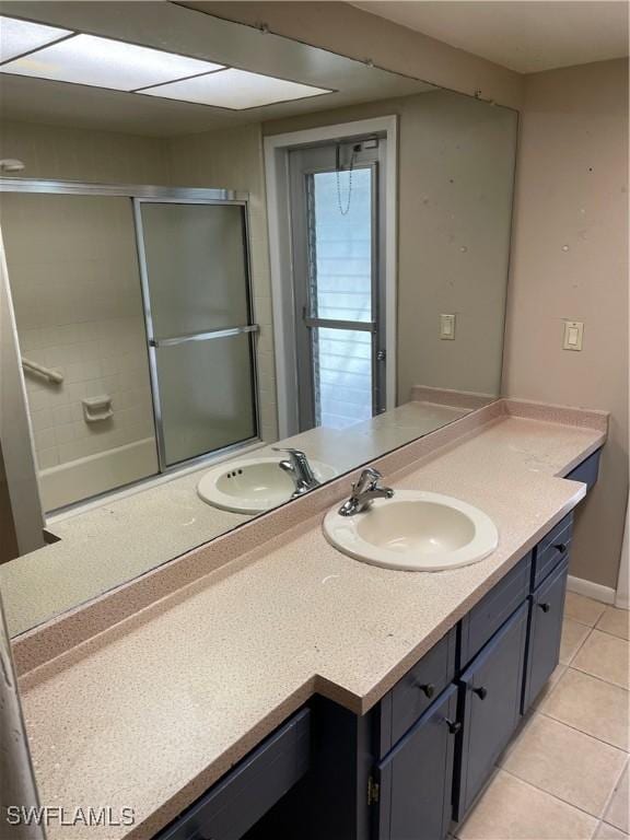 bathroom featuring tile patterned floors, vanity, and walk in shower