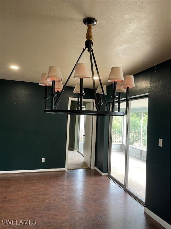 room details featuring hardwood / wood-style flooring, a textured ceiling, and a chandelier