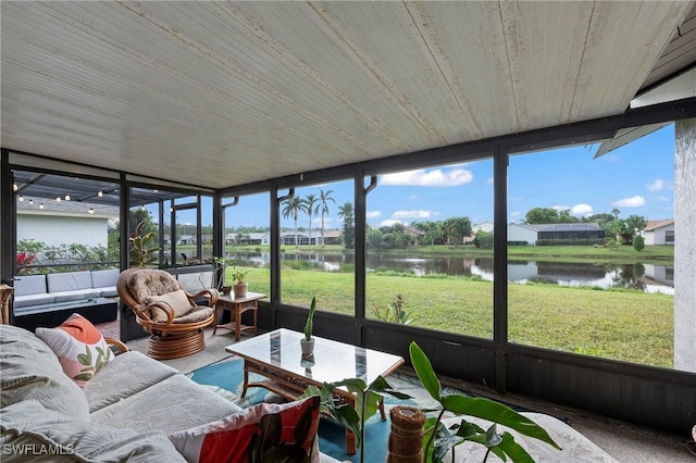 sunroom / solarium with a water view