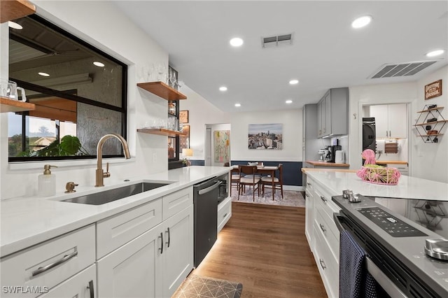 kitchen with white cabinets, dark hardwood / wood-style floors, sink, and appliances with stainless steel finishes