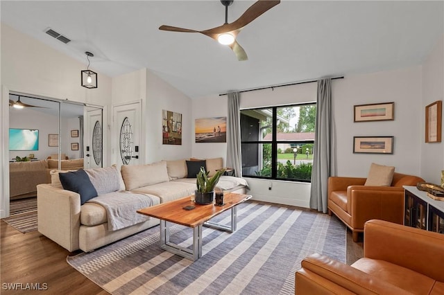 living room featuring hardwood / wood-style floors, vaulted ceiling, and ceiling fan