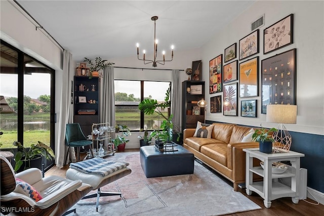 sitting room with a chandelier and wood-type flooring