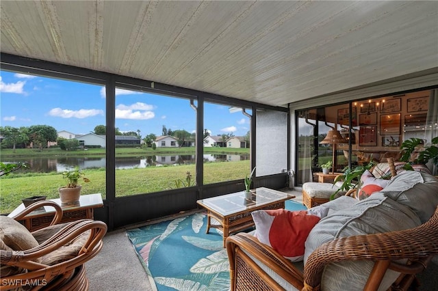 sunroom featuring a water view