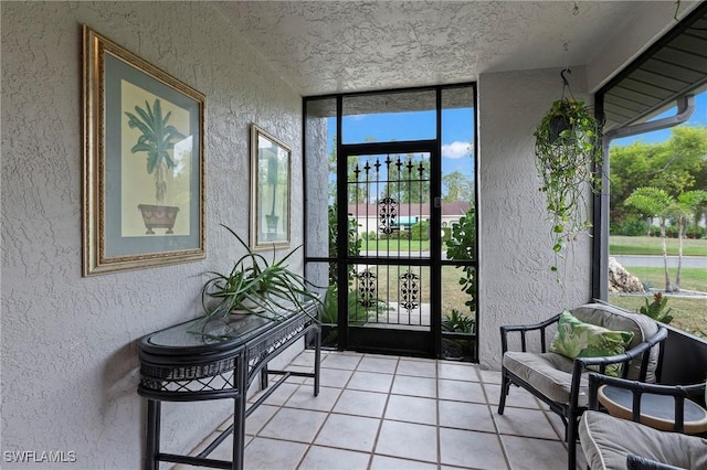 tiled foyer entrance featuring a wall of windows