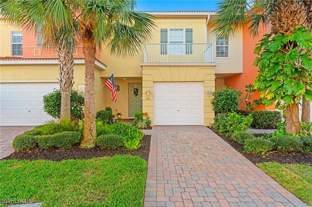 view of front of property with a garage and a balcony