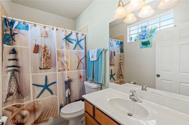 bathroom with walk in shower, vanity, and toilet