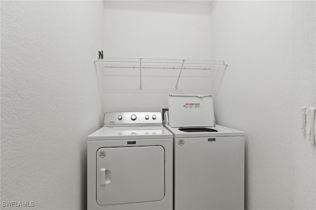 washroom with separate washer and dryer