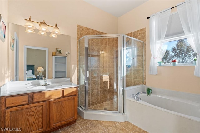 bathroom featuring tile patterned flooring, shower with separate bathtub, and vanity