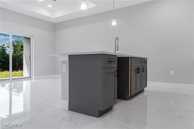 kitchen with pendant lighting, gray cabinetry, and sink