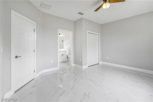 unfurnished bedroom with ceiling fan, a closet, and ensuite bathroom