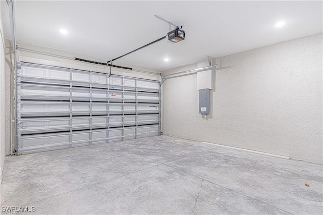 garage featuring electric panel and a garage door opener