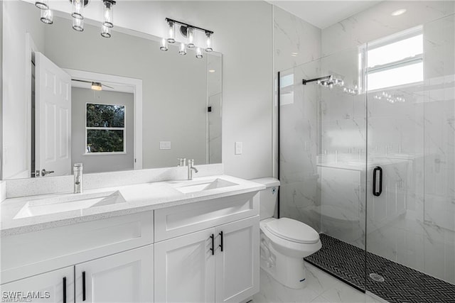 bathroom featuring ceiling fan, vanity, an enclosed shower, and toilet