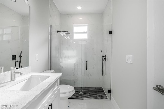 bathroom with vanity, toilet, and a shower with door