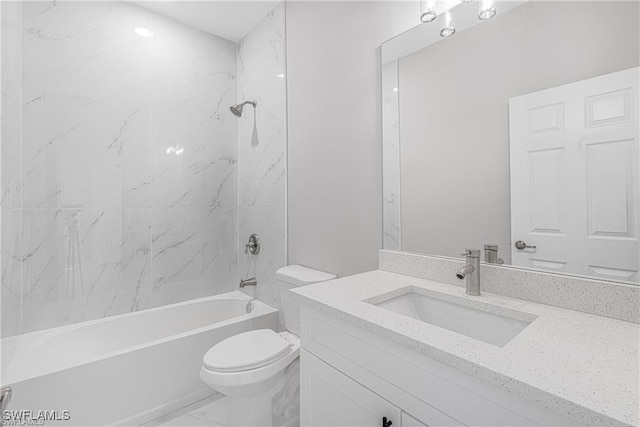 full bathroom featuring vanity, tiled shower / bath combo, and toilet