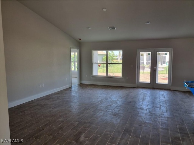 spare room with baseboards, visible vents, dark wood finished floors, and french doors