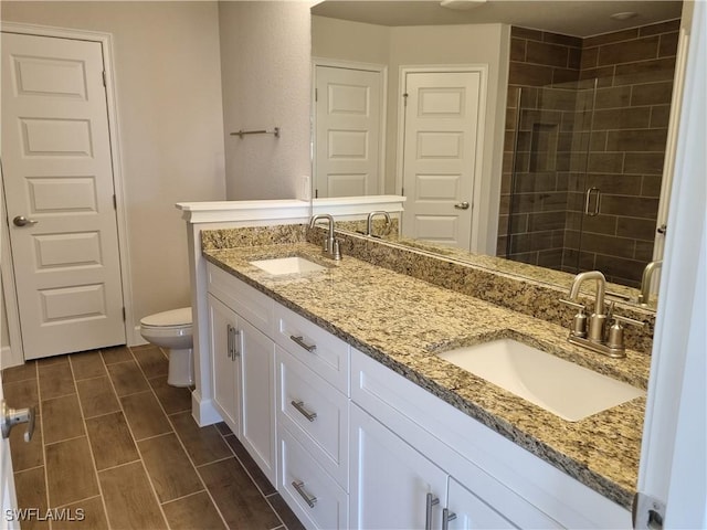 125 NW 9th Ter, Cape Coral, FL 33993 - full bath featuring toilet, double vanity, and a stall shower