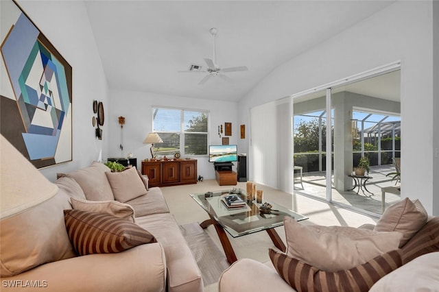 carpeted living room featuring ceiling fan, a healthy amount of sunlight, and lofted ceiling