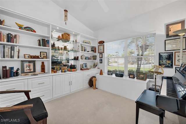 interior space featuring light carpet, ceiling fan, and lofted ceiling