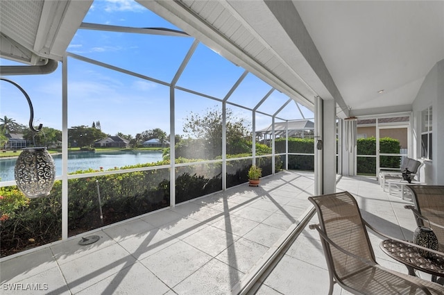 unfurnished sunroom with a water view and lofted ceiling