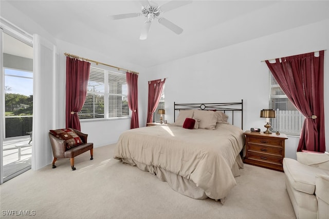 carpeted bedroom featuring ceiling fan and access to exterior