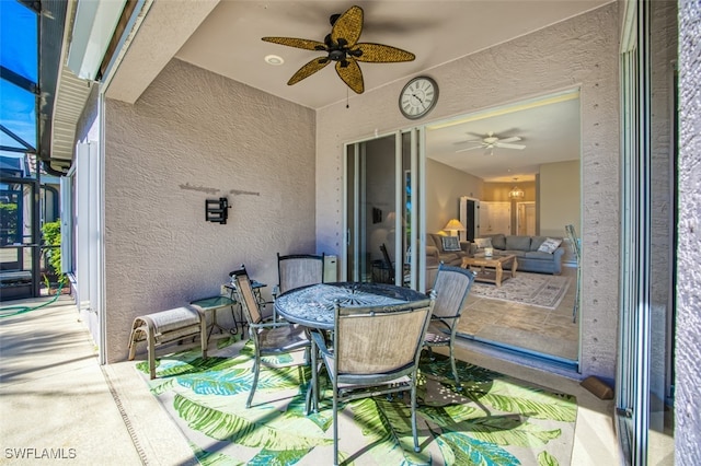 view of patio / terrace with ceiling fan and glass enclosure