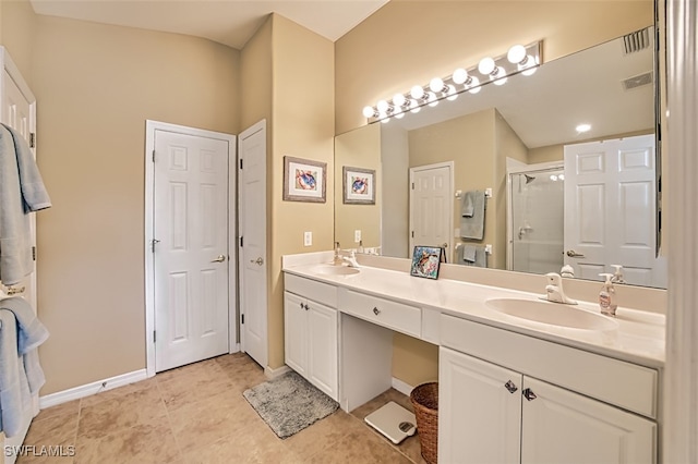 bathroom featuring tile patterned floors, vanity, and walk in shower