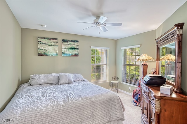 bedroom with light colored carpet and ceiling fan