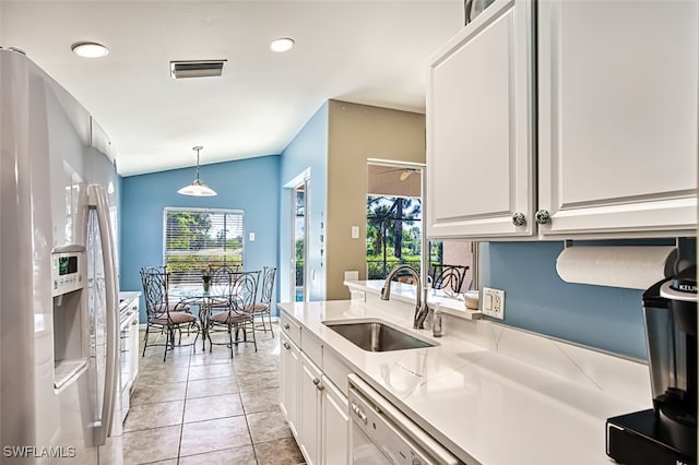 kitchen featuring sink, hanging light fixtures, stainless steel fridge with ice dispenser, vaulted ceiling, and white cabinets