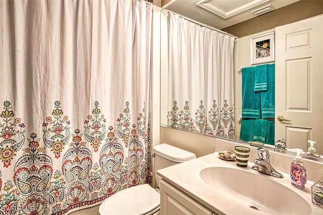 bathroom with vanity, a shower with shower curtain, and toilet