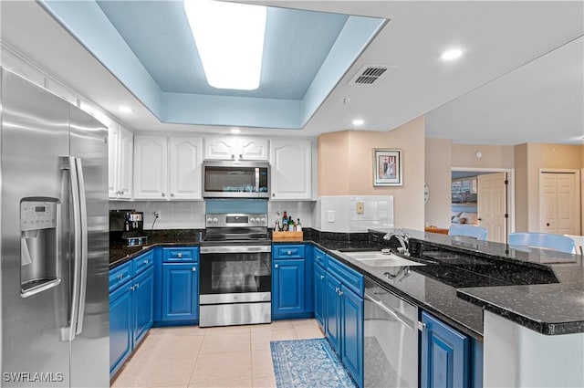 kitchen featuring appliances with stainless steel finishes, white cabinetry, blue cabinets, and sink